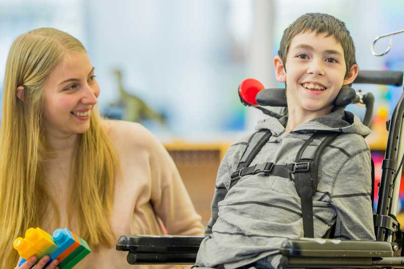 A child playing in his Paediatric Powerchair