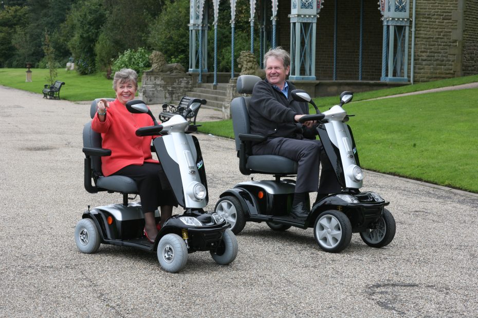 Kymco Maxi Mobility Scooters being used to get around the park